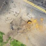 a-us-bomb-from-world-war-ii-explodes-at-a-japanese-airport,-causing-a-large-crater-in-a-taxiway