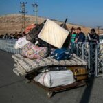 hundreds-of-syrians-line-up-at-turkish-border-crossing,-awaiting-return-home