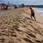 as-spaniards-summer-at-barcelona’s-beaches,-some-worry-about-the-erosion-of-coastline