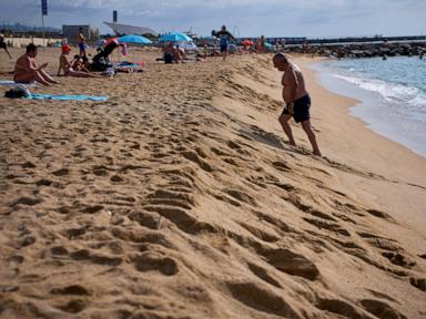 as-spaniards-summer-at-barcelona’s-beaches,-some-worry-about-the-erosion-of-coastline