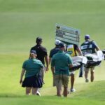 vince-whaley-has-an-audience-with-a-set-of-teeth.-he-hits-shot-with-alligator-behind-him