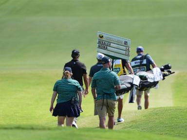 vince-whaley-has-an-audience-with-a-set-of-teeth.-he-hits-shot-with-alligator-behind-him