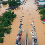 families-in-thailand-perch-on-rooftops-to-escape-flooding-that-has-killed-at-least-33